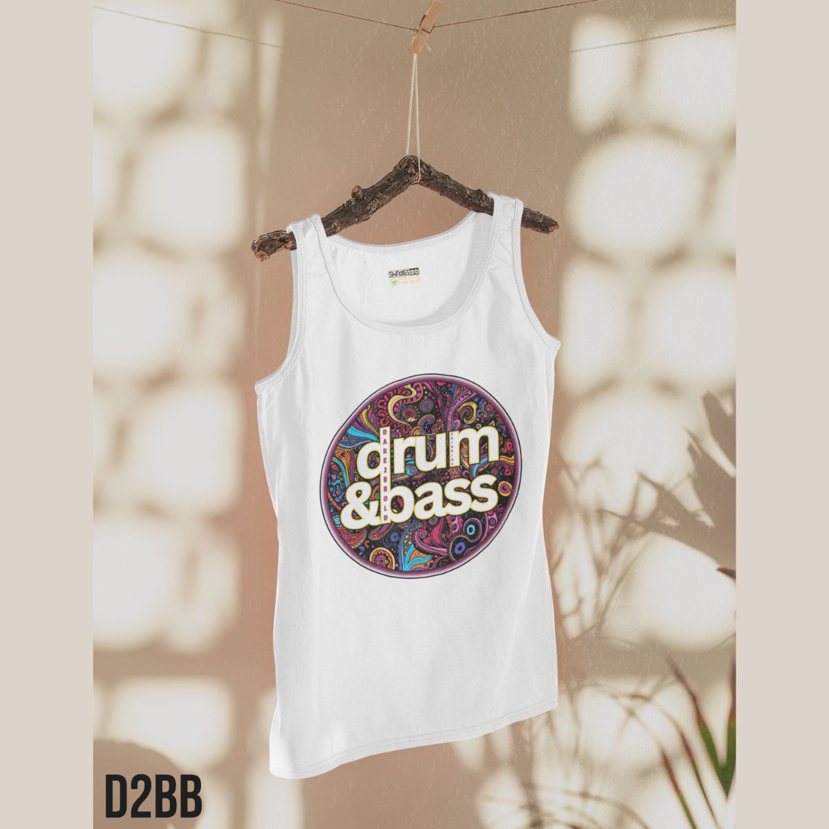 White tank top with 'drum & bass' design on a hanger against a neutral background
