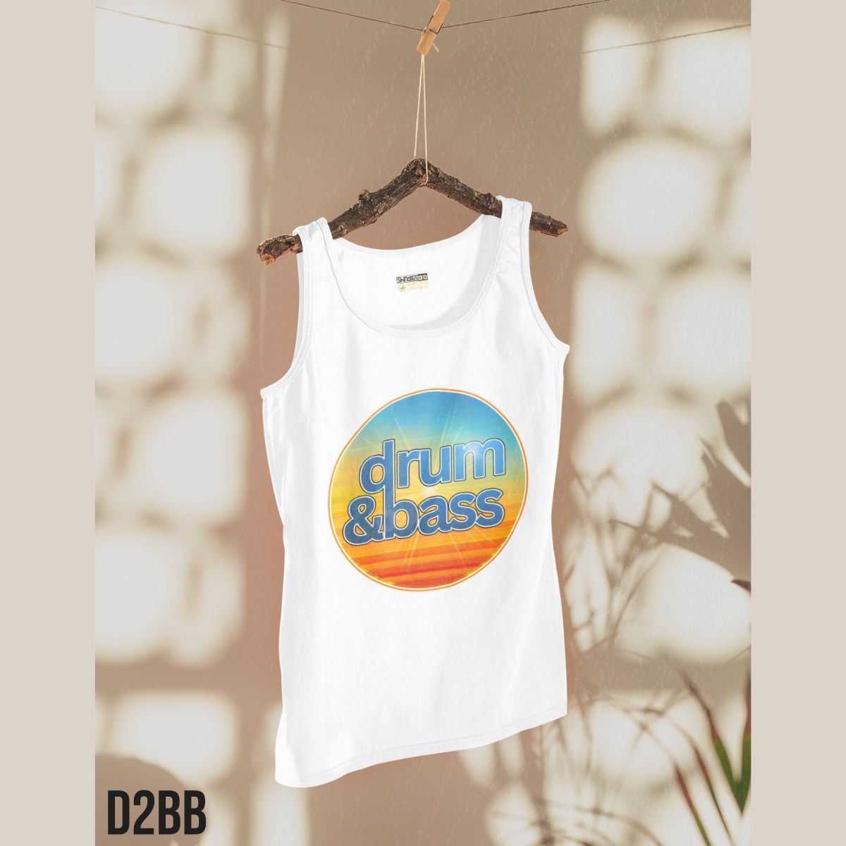 White tank top with 'drum & bass' design on a hanger against a neutral background