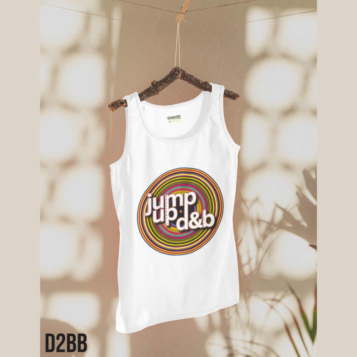 White tank top with colorful 'Jump up d&b' design on a hanger against a neutral background
