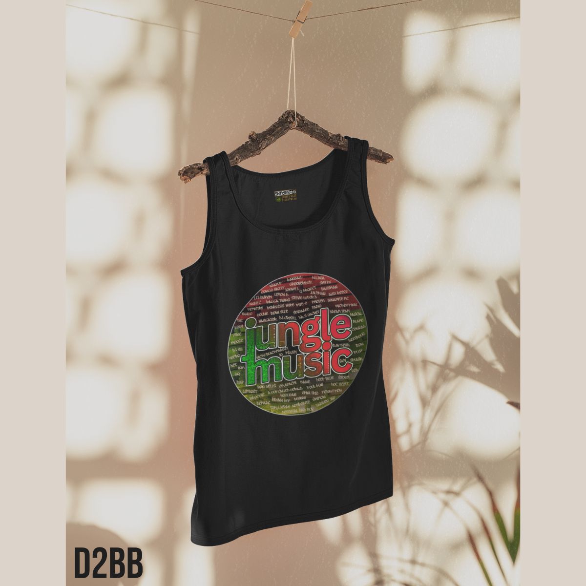 Black tank top with 'jungle music' design on a hanger against a neutral background