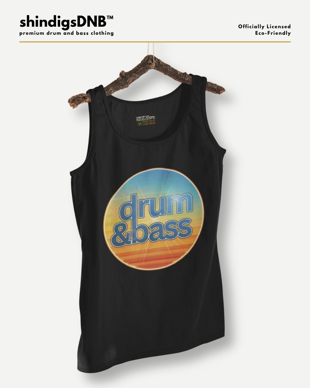A black tank top hanging on a rustic wooden hanger against a light gray background. The tank top features a large circular graphic in the center with a blue-to-yellow sunset gradient and the words 'drum & bass' in blue.