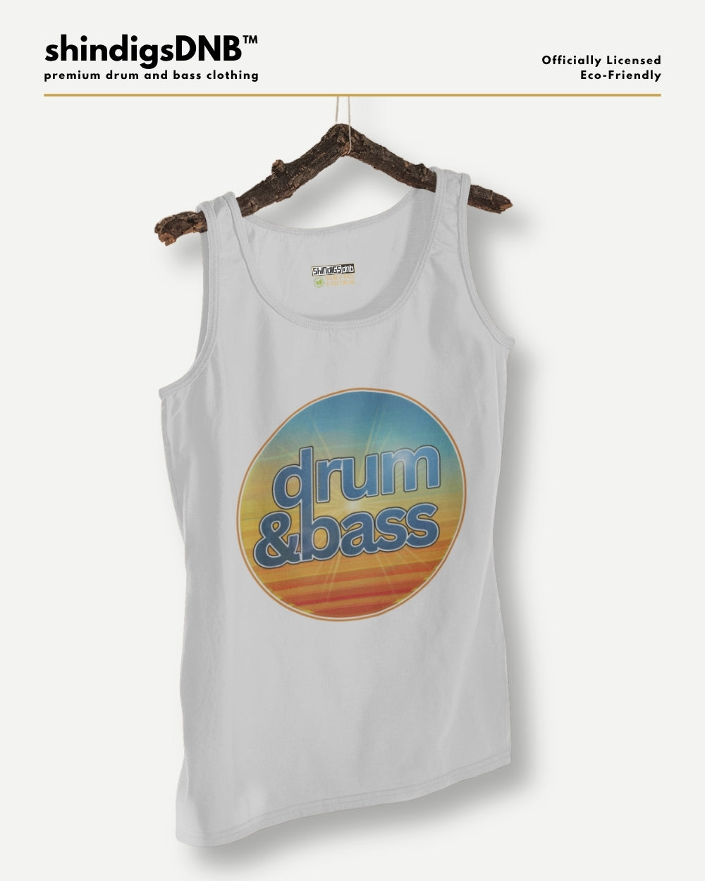 A white tank top hanging on a rustic wooden hanger against a light gray background. The tank top features a large circular retro-style graphic on the front with the words 'drum & bass' in blue over a yellow, orange, and blue sunset gradient.