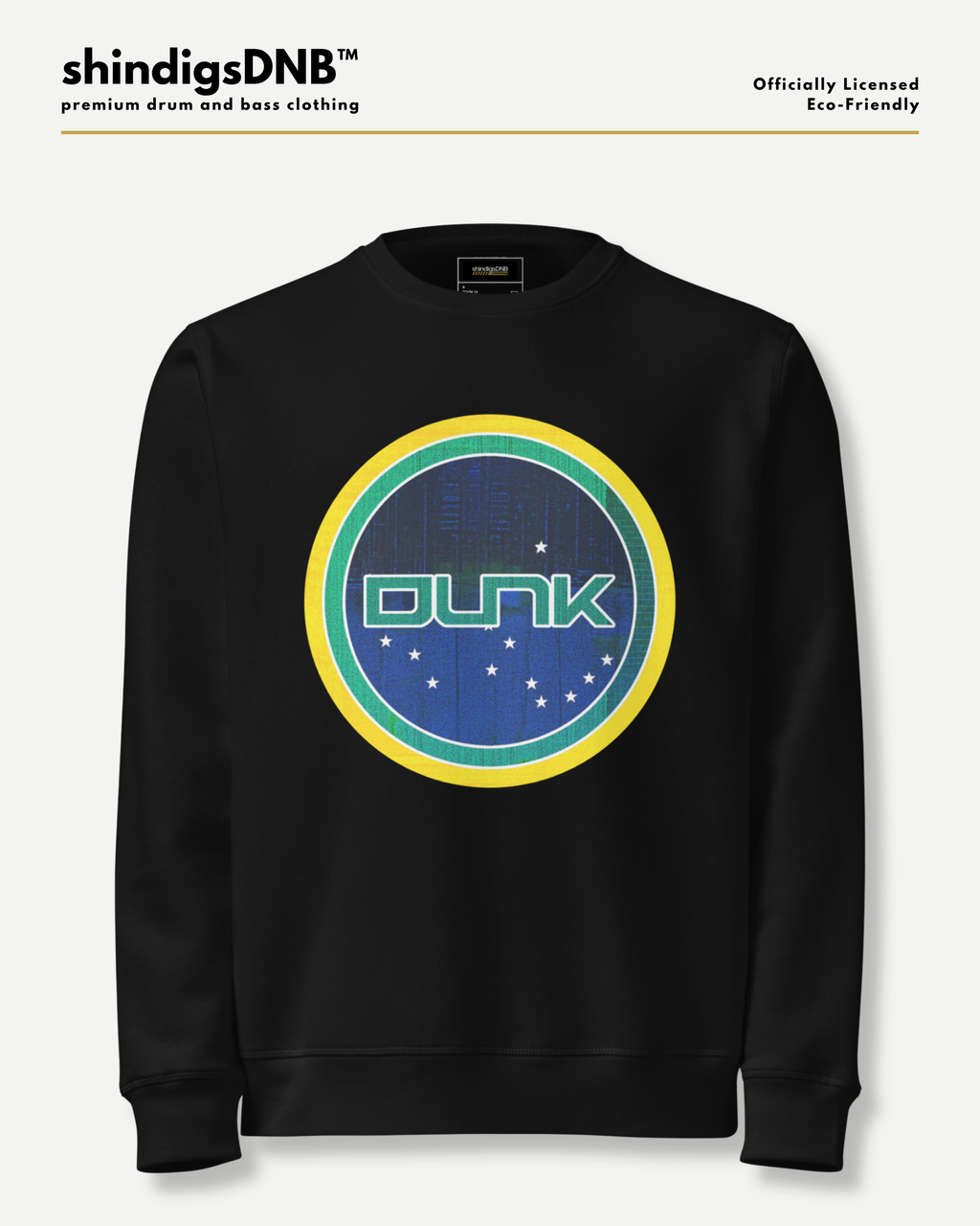 A black crewneck sweatshirt featuring a circular graphic on the chest with the word 'DUNK' in green, surrounded by yellow and teal rings over a blue starry background. The sweatshirt is displayed on a light gray background with branding text at the top.