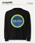 A black crewneck sweatshirt featuring a circular graphic on the chest with the word 'DUNK' in green, surrounded by yellow and teal rings over a blue starry background. The sweatshirt is displayed on a light gray background with branding text at the top.
