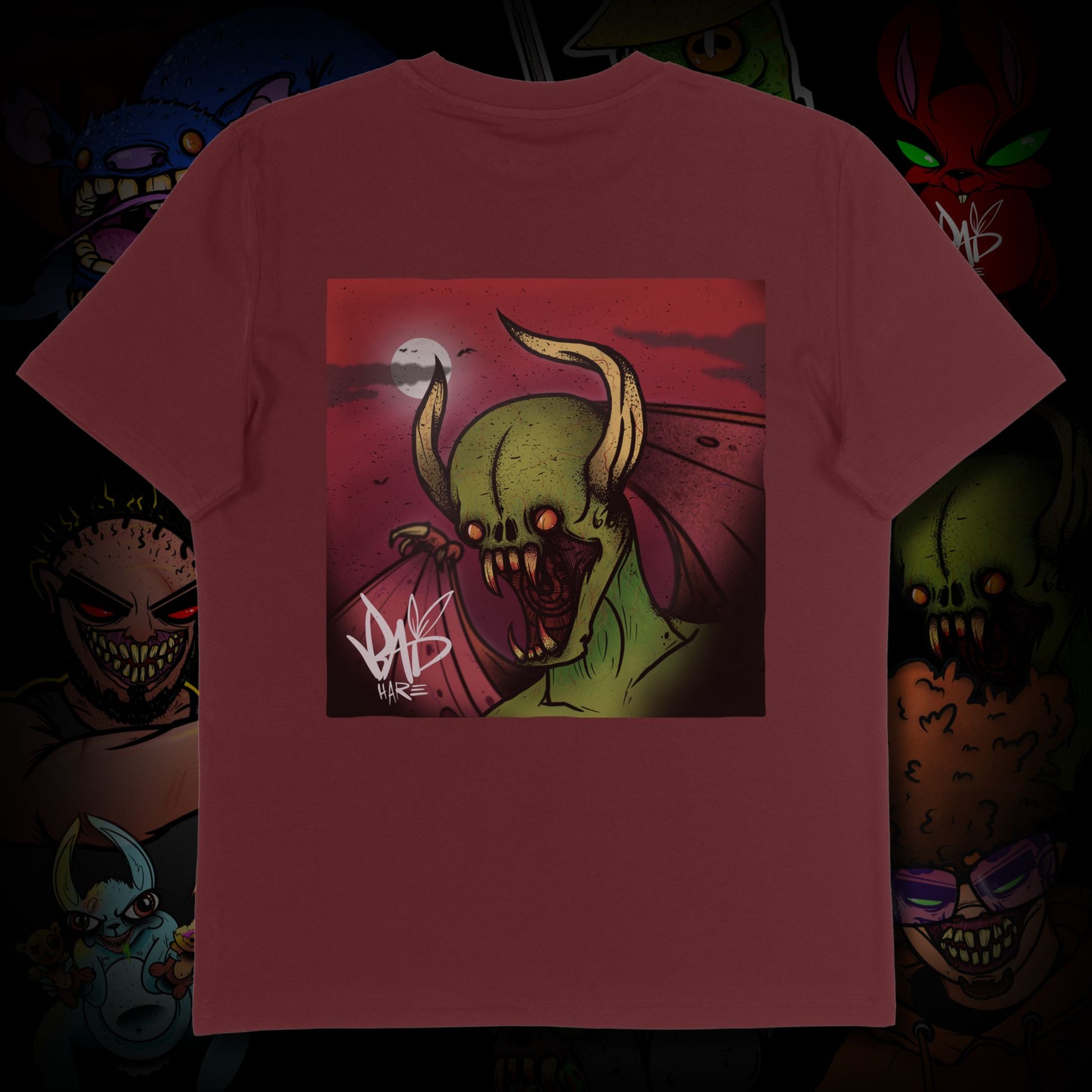 Maroon t-shirt with a graphic design of a green creature on a dark background
