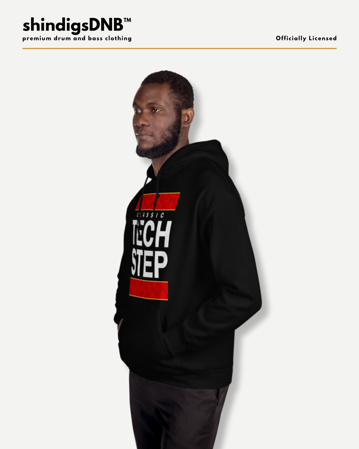 A man wearing a black hoodie with a red and white graphic print saying 'Classic Tech Step' on the front, shown in profile against a light gray background. The brand name 'shindigsDNB' is visible at the top left.
