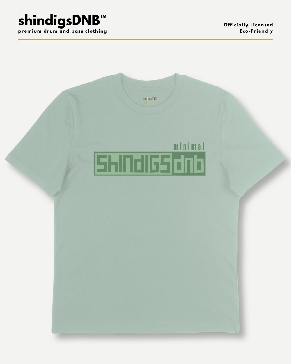 A light sage green t-shirt with a green graphic print on the chest reading 'minimal SHINDIGSDNB'. The image is presented on a clean white background with branding text at the top left and right.