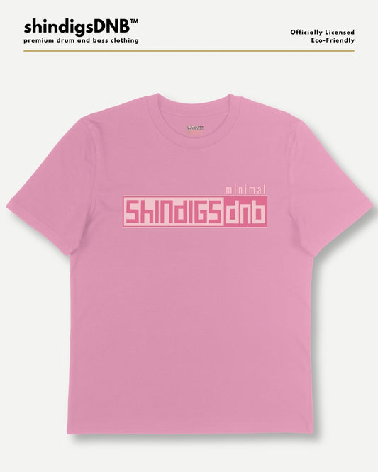 A pink short-sleeve t-shirt with a pink graphic print on the chest reading 'shindigsdnb' and 'minimal', displayed on a light gray background with brand text at the top.