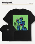 Black short-sleeve graphic t-shirt shown in two views: a large front view featuring a green square with a blue cartoon character, and a smaller back view showing a small white logo on the left chest. The brand name 'shindigsDNB' is visible at the top.
